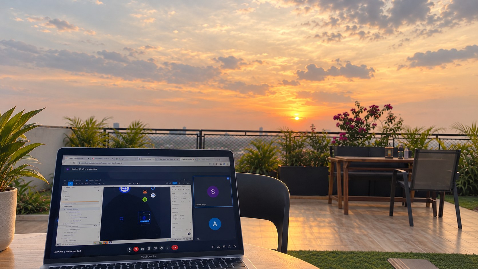 A laptop open to an online meeting on a rooftop terrace at sunset, with potted plants, a flowering bougainvillea and a city skyline beyond the railing